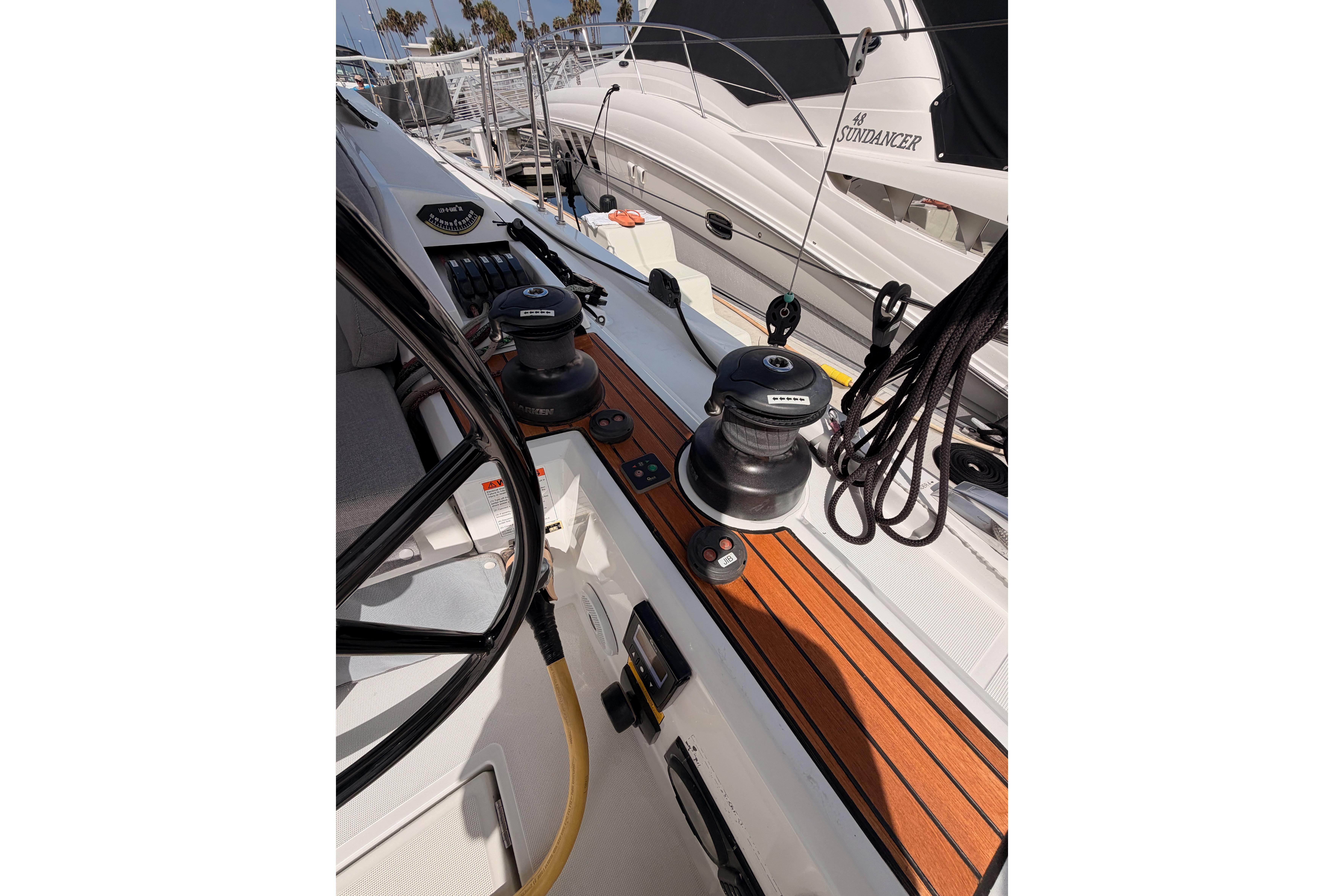 2020 Beneteau Oceanis 46.1 yacht deck with winches and ropes, docked at marina.