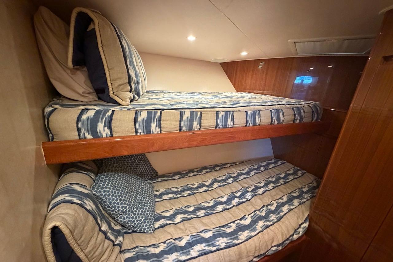 Bunk beds in 2012 Viking 50 Convertible yacht cabin with striped bedding.