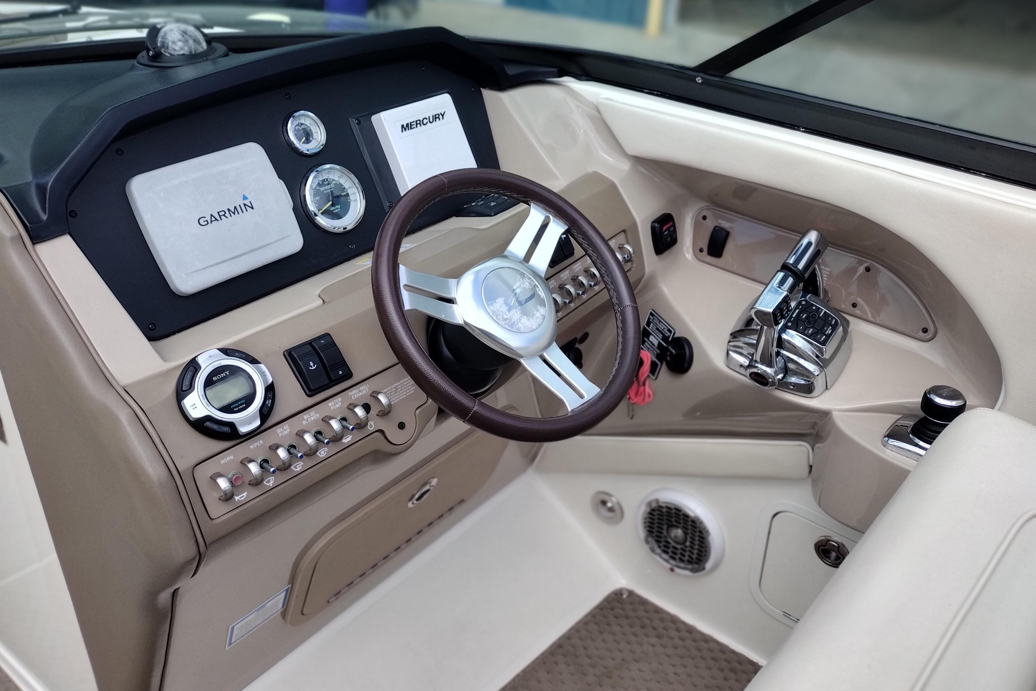 Interior dashboard of a 2013 Sea Ray 300 SLX boat with Garmin and Mercury controls.