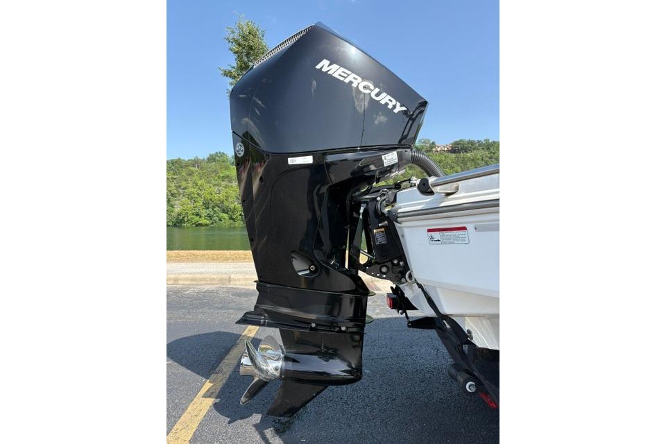 2024 Tahoe T21 boat with Mercury outboard motor, parked near a scenic lake.