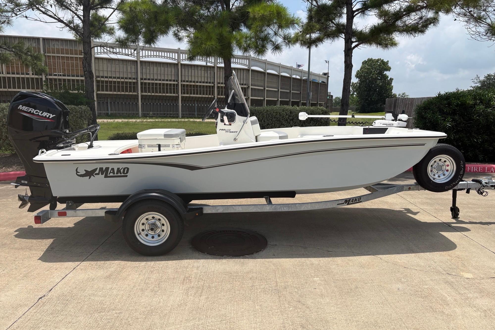 2026 Mako Pro Skiff 15 CC boat on trailer, parked outdoors.