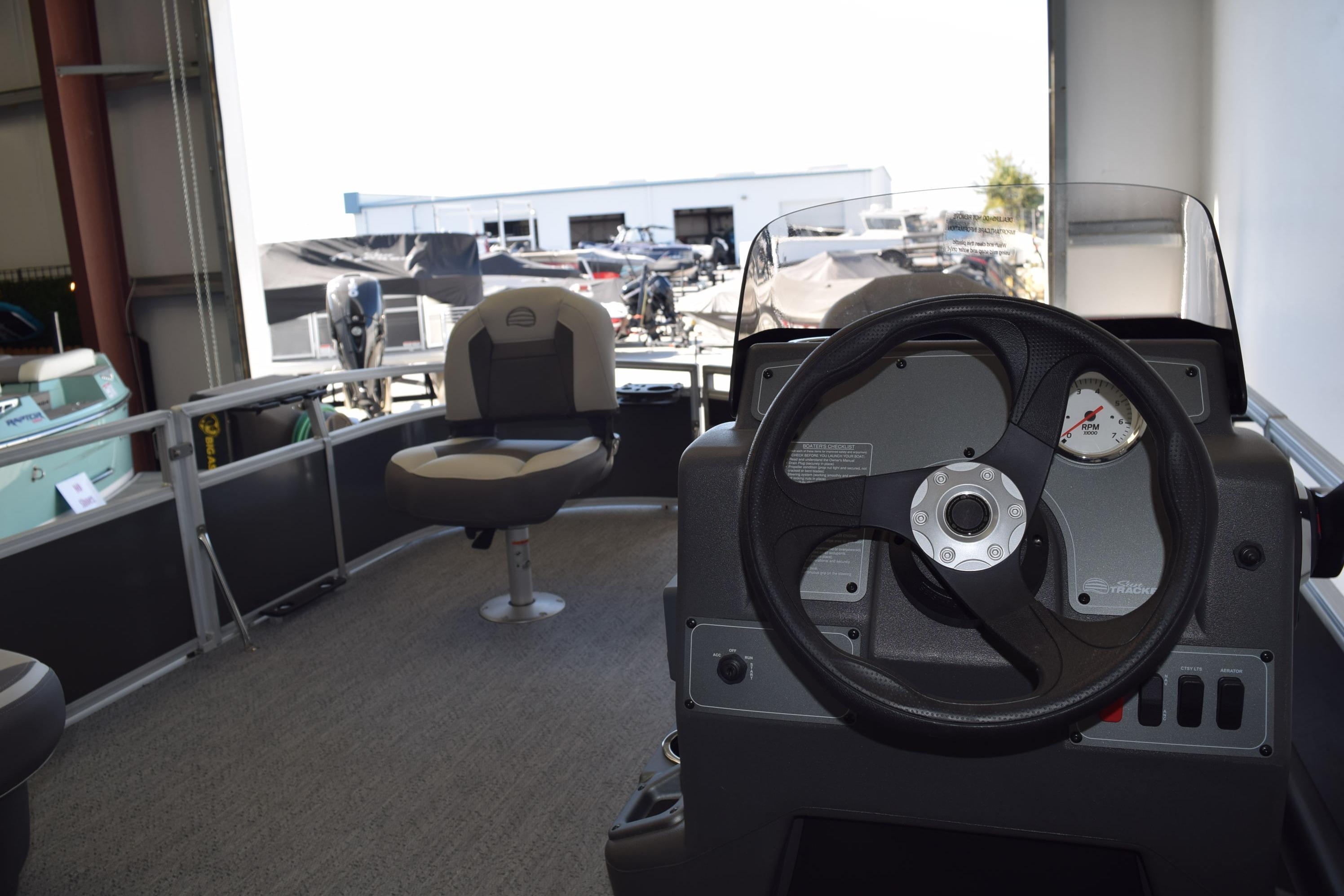 2026 Sun Tracker Bass Buggy 16 XL Select interior with steering wheel and seating.