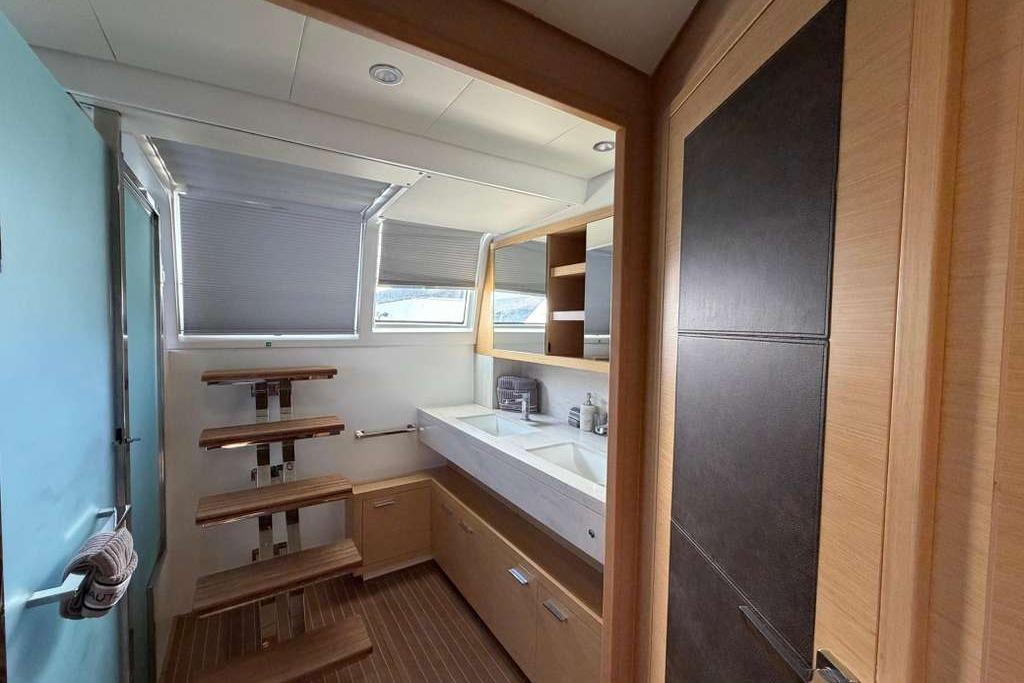 Luxurious bathroom interior of 2019 Lagoon 630 MY yacht with modern fixtures and wooden accents.