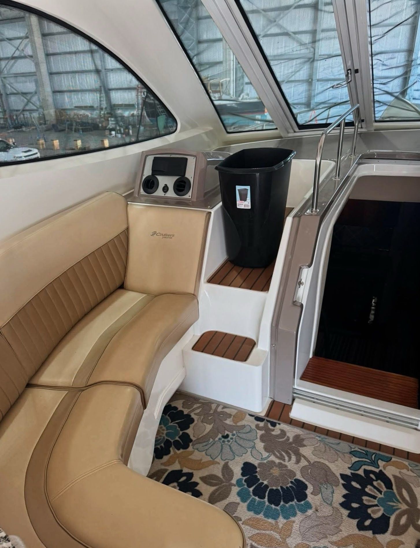 Interior of a 2009 Cruisers Yachts 520 Sports Coupe with beige seating and a carpet.