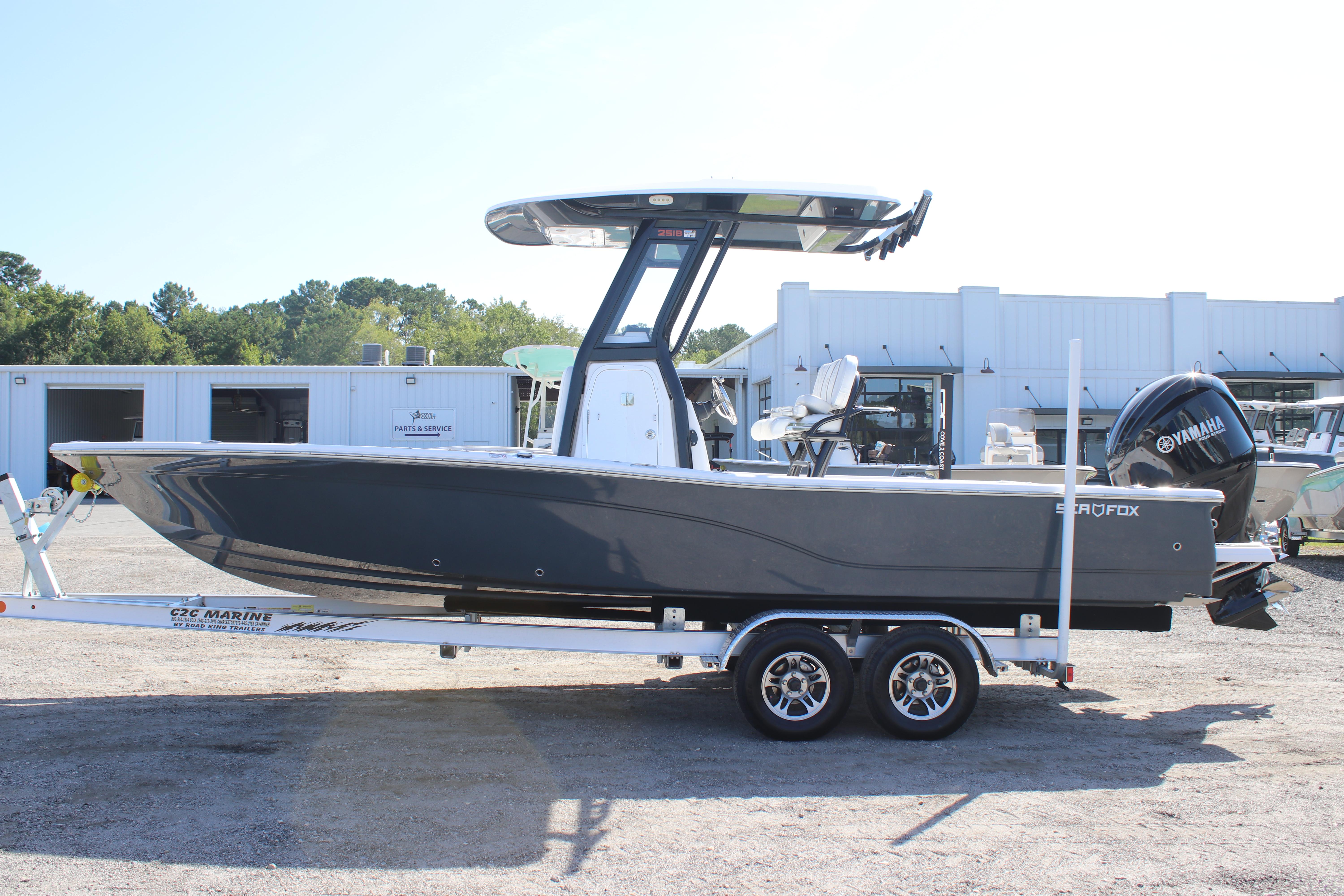 2025 Sea Fox 251 Bay Fox boat on trailer, parked outdoors.