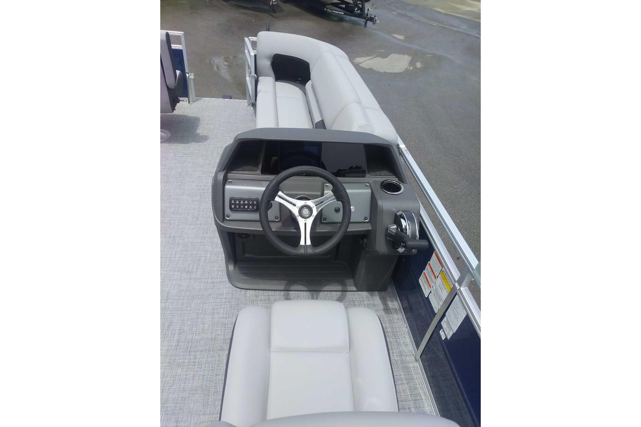 2026 Sun Tracker SportFish 20 DLX boat interior with steering console and seating.