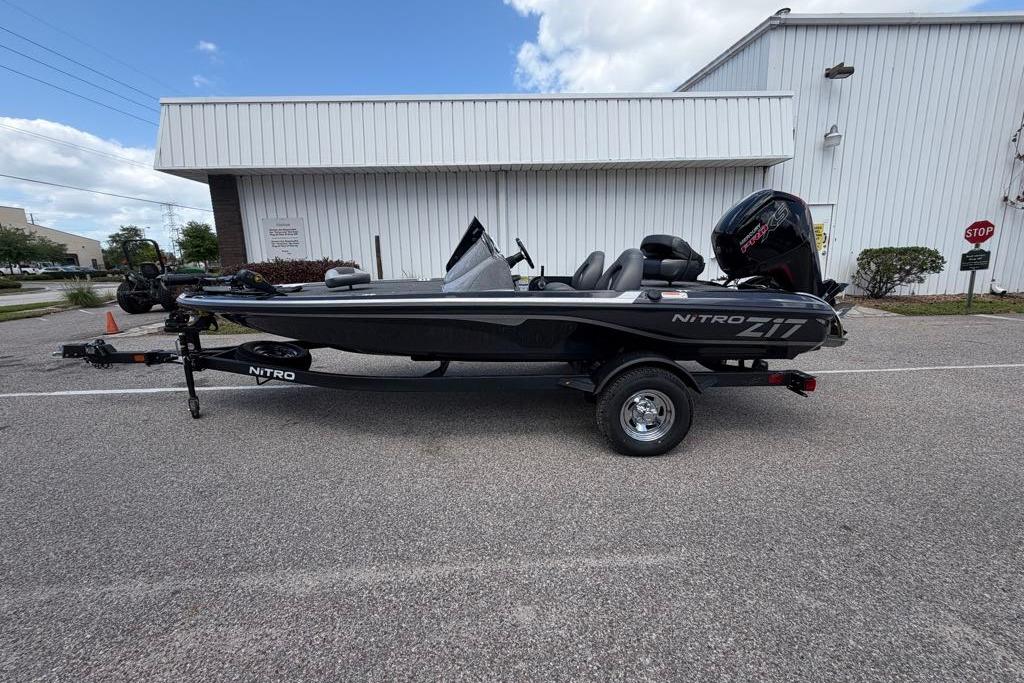 2026 Nitro Z17 boat on trailer, parked outside a white building.