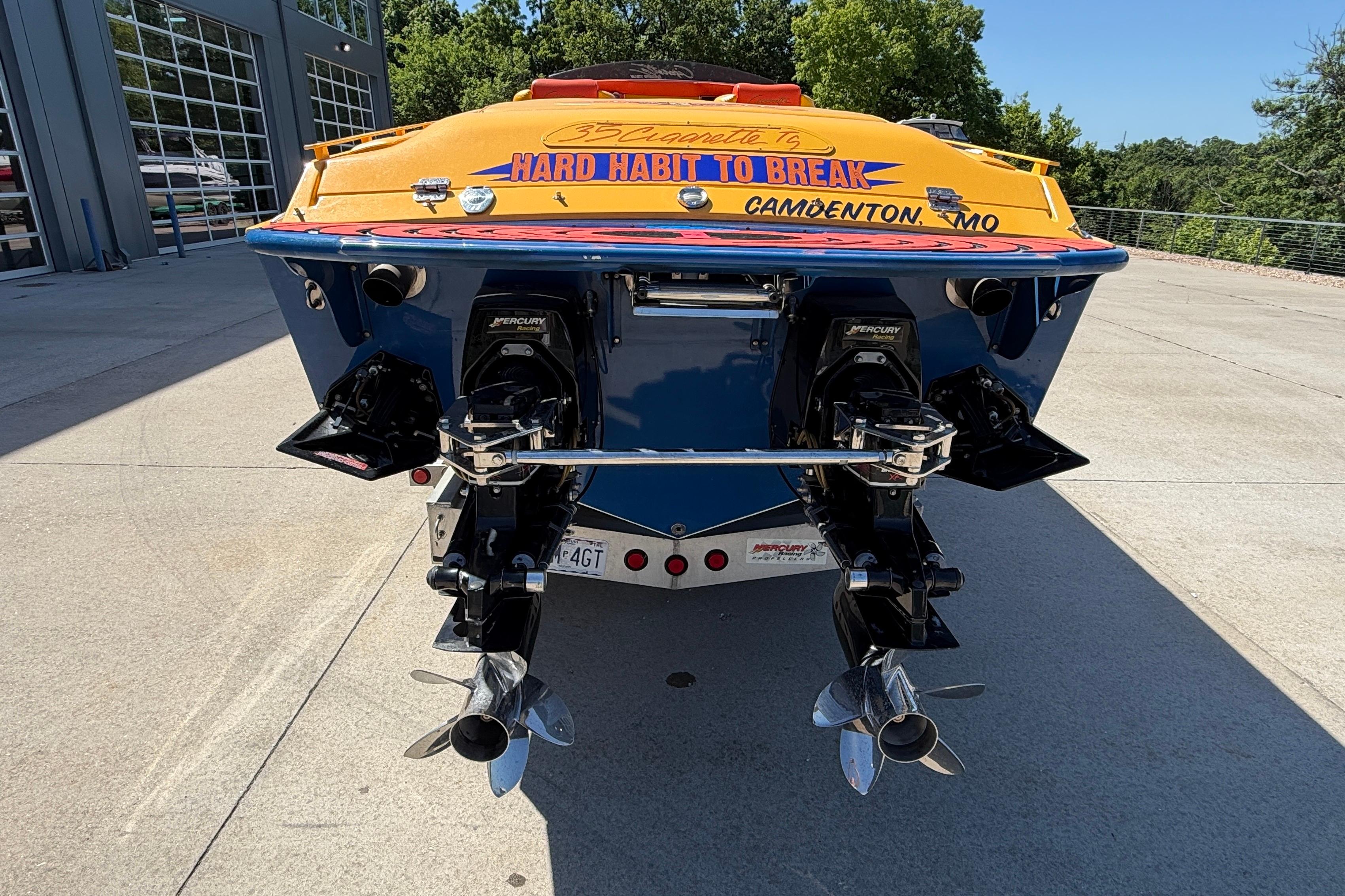 Rear view of a 2002 Cigarette 35' Cafe Racer boat with dual Mercury engines.