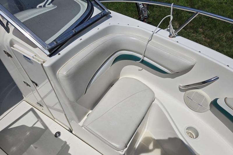 2004 Aquasport 215 Osprey Sport boat interior with white seating and green accents.