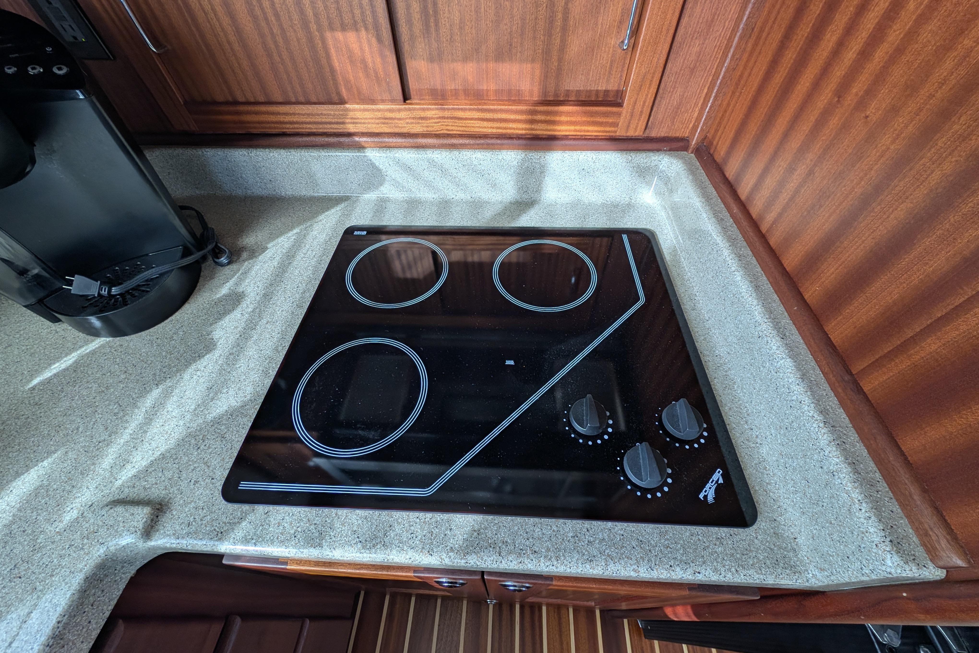 Modern kitchen stove in 2015 American Tug 435 boat galley.