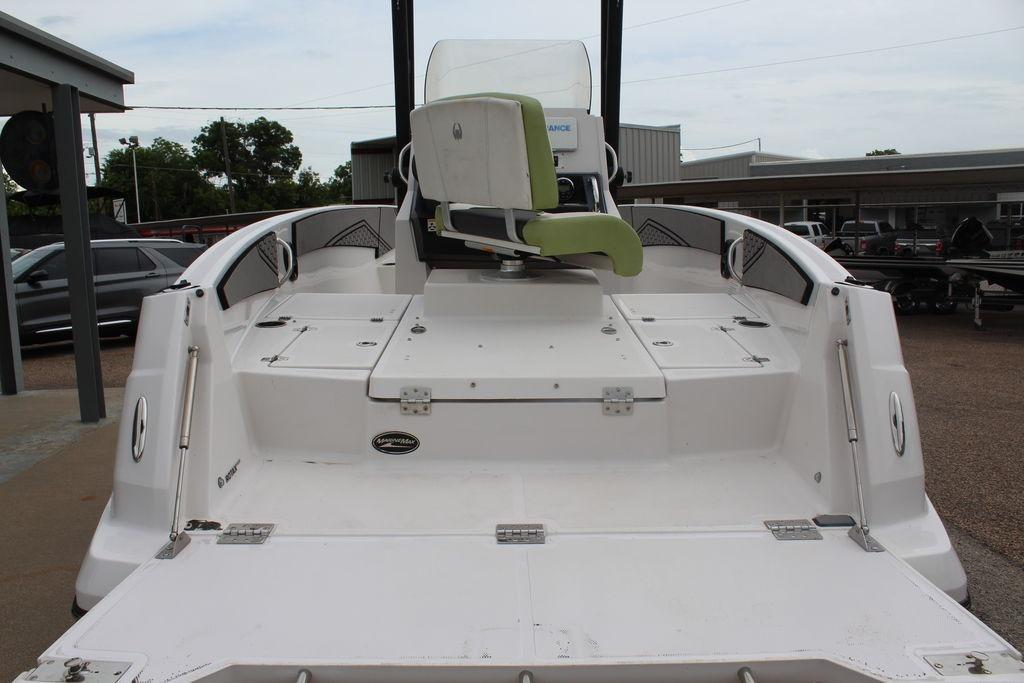 2017 Scarab 195 boat with white deck and green seat, parked outdoors.