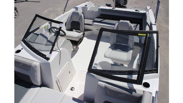 2025 Starcraft SVX 210 OB DC boat interior with seating and steering wheel.