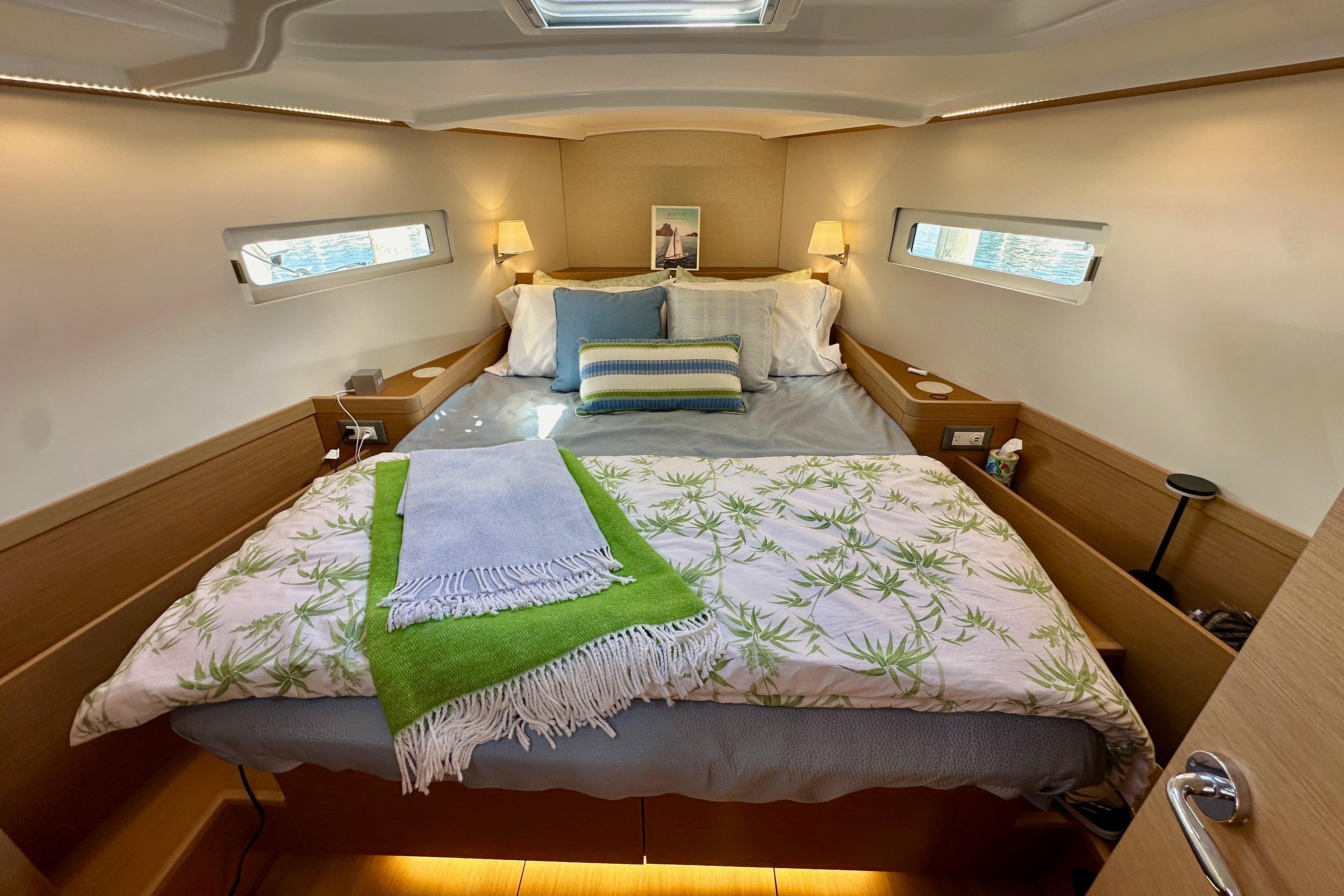 Luxurious cabin interior of 2024 Jeanneau Sun Odyssey 410 sailboat, featuring a cozy bed.