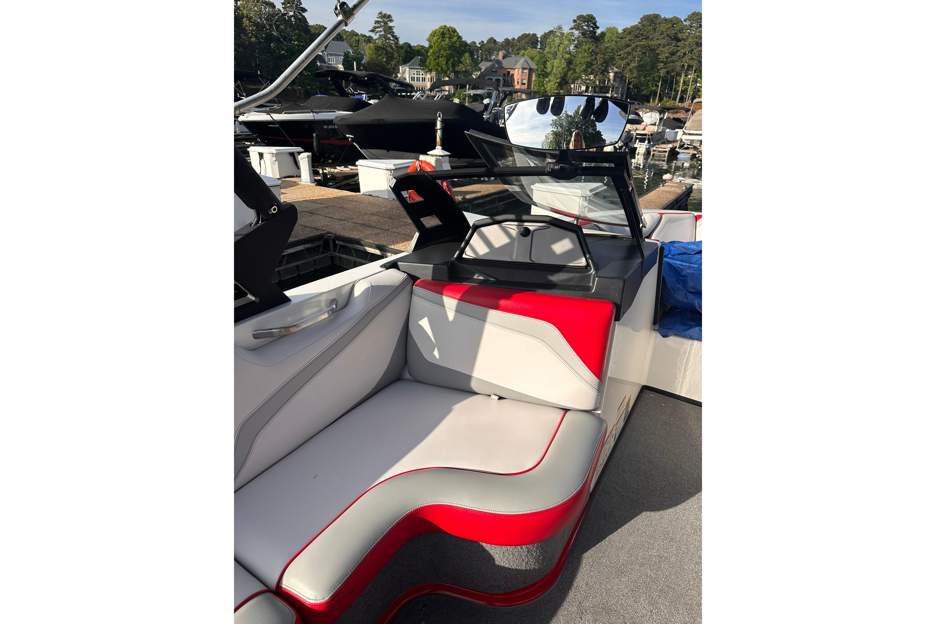 2017 Axis T23 boat interior with red and gray seating at a marina.