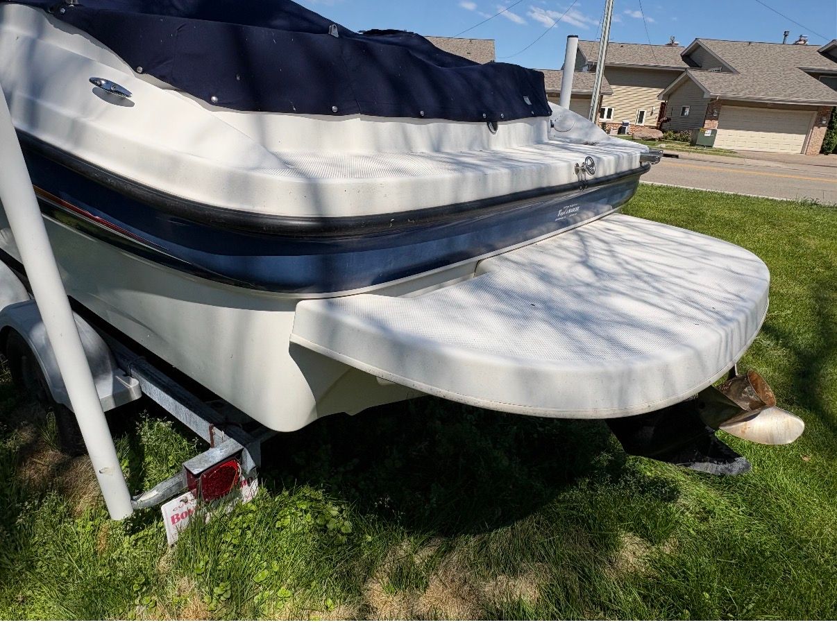 Bayliner 212 Open Bow from 2005 on a trailer outdoors.
