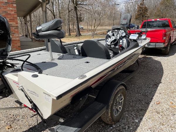 2021 Tracker Pro 195 XTE boat on trailer, parked beside a red truck.