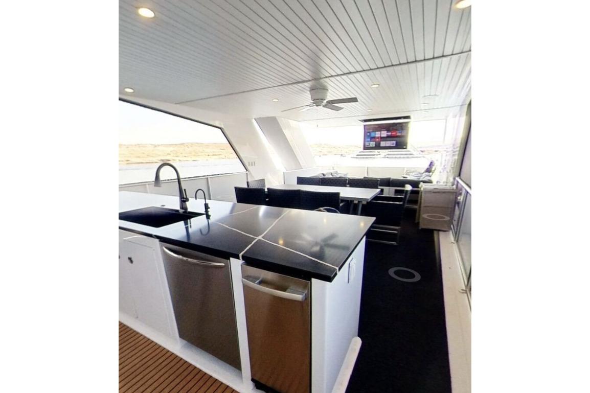 Luxurious yacht interior with modern kitchen and dining area, Adonia Galileo Trip 2023.