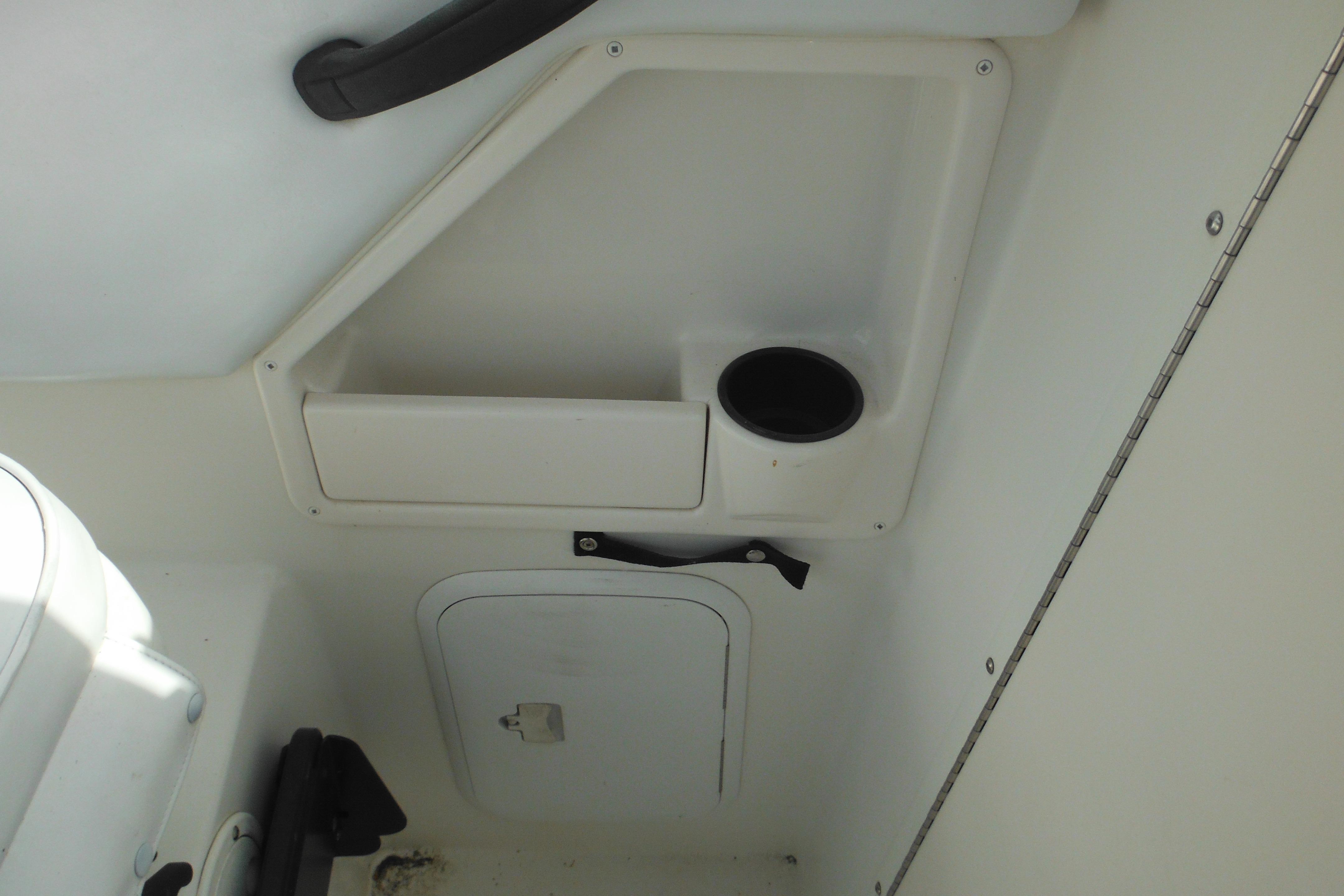 Interior of 2005 Seaswirl Striper 2101 Walkaround O/B boat, featuring storage compartment.