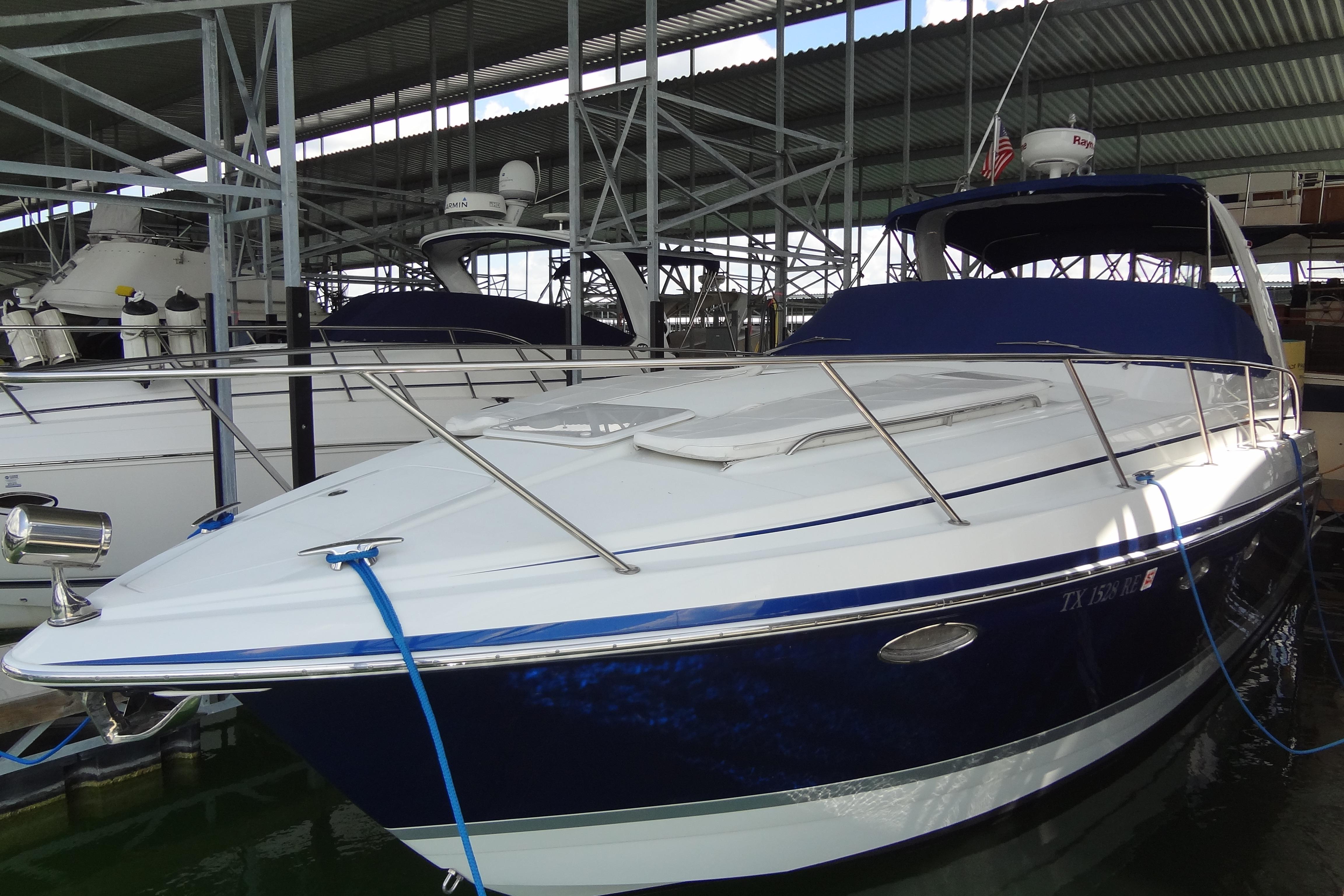 2007 Formula 34 Performance Cruiser docked in a marina, featuring sleek design and blue accents.