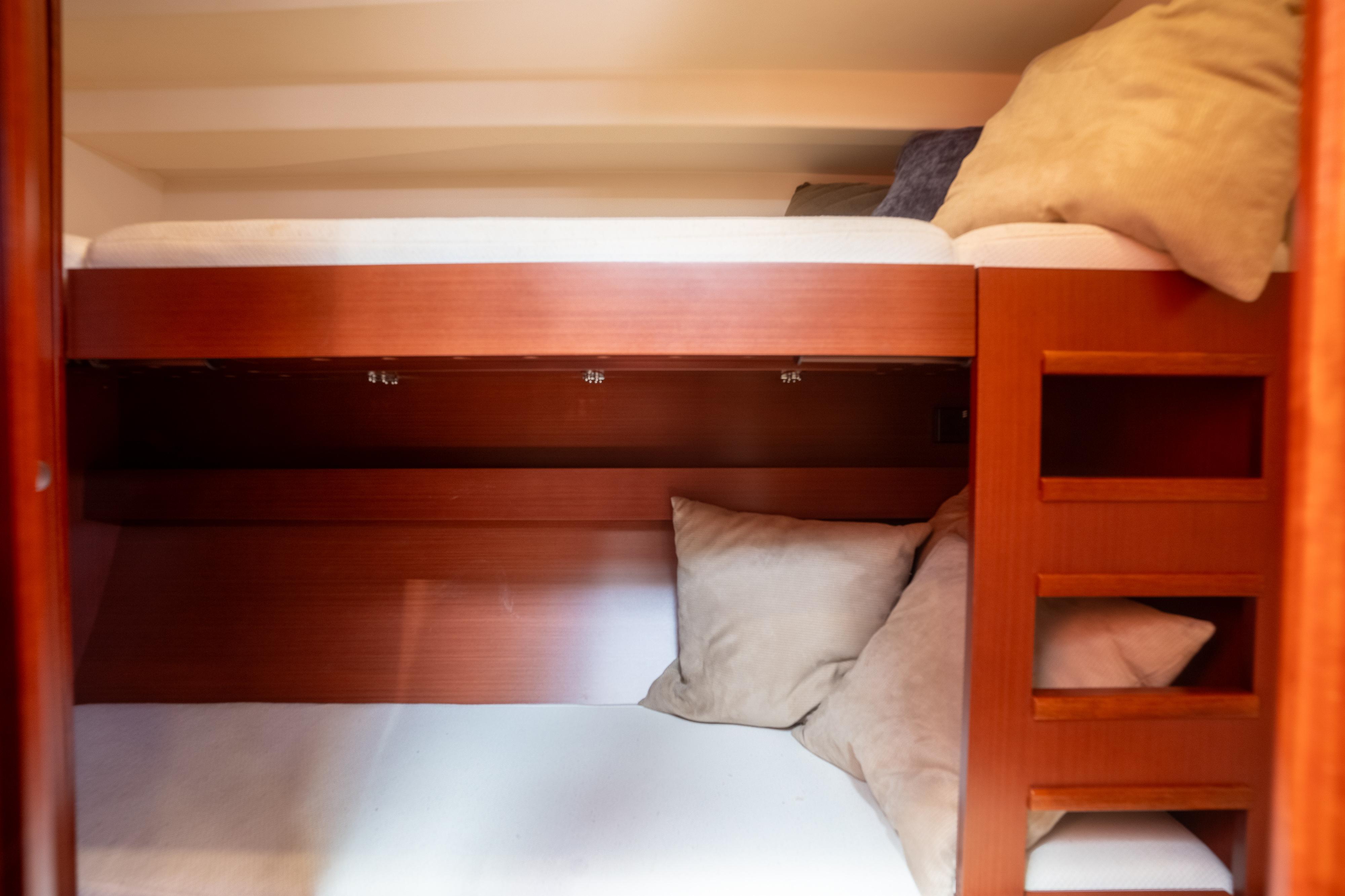 Cozy bunk beds in 2013 Hanse 575 yacht cabin with wooden finish.