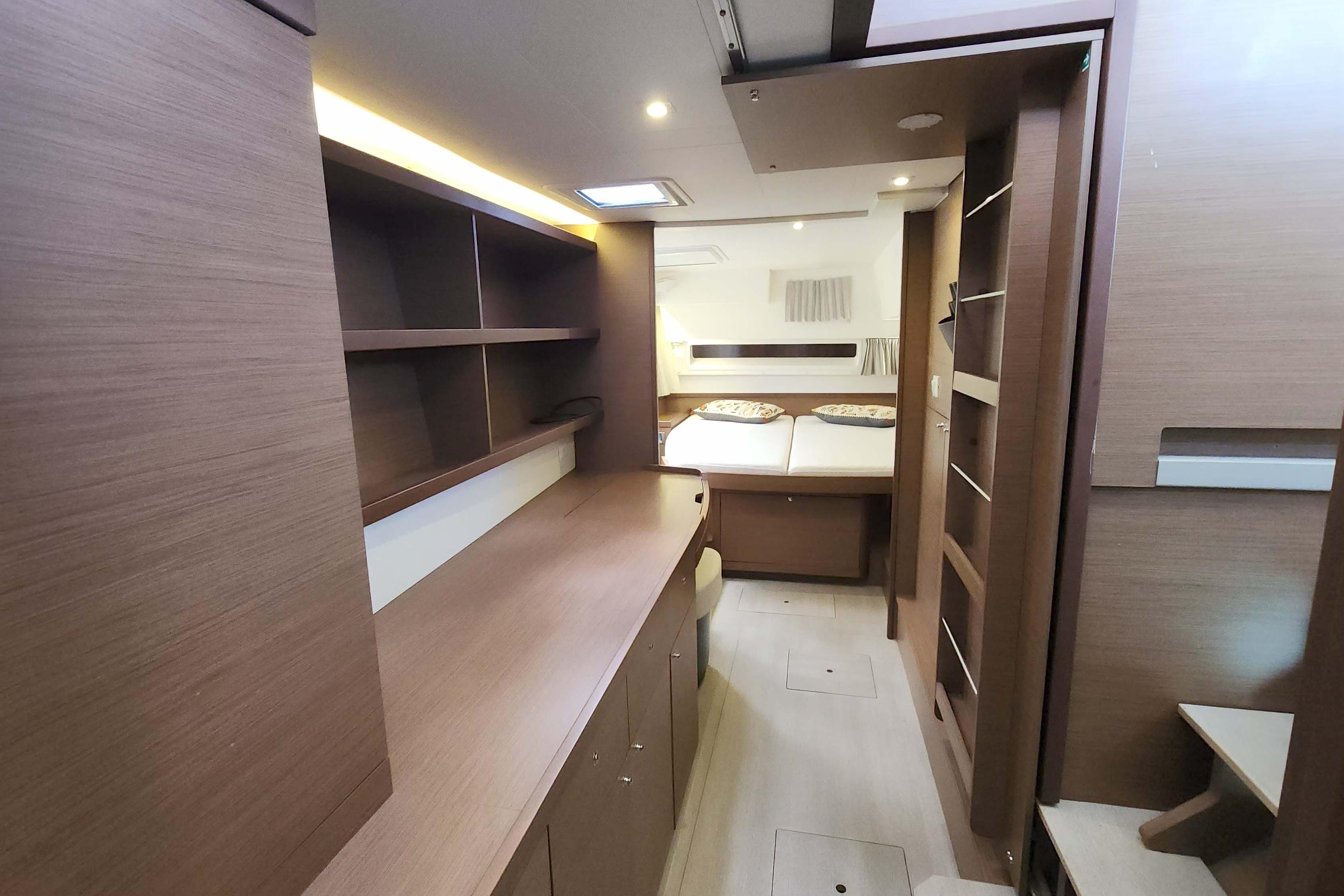 Luxurious interior of 2020 Lagoon 42 catamaran with modern wood finish and cozy bedroom.