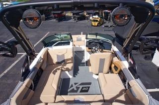 2025 MasterCraft XT20 boat interior with beige seating and advanced audio system.