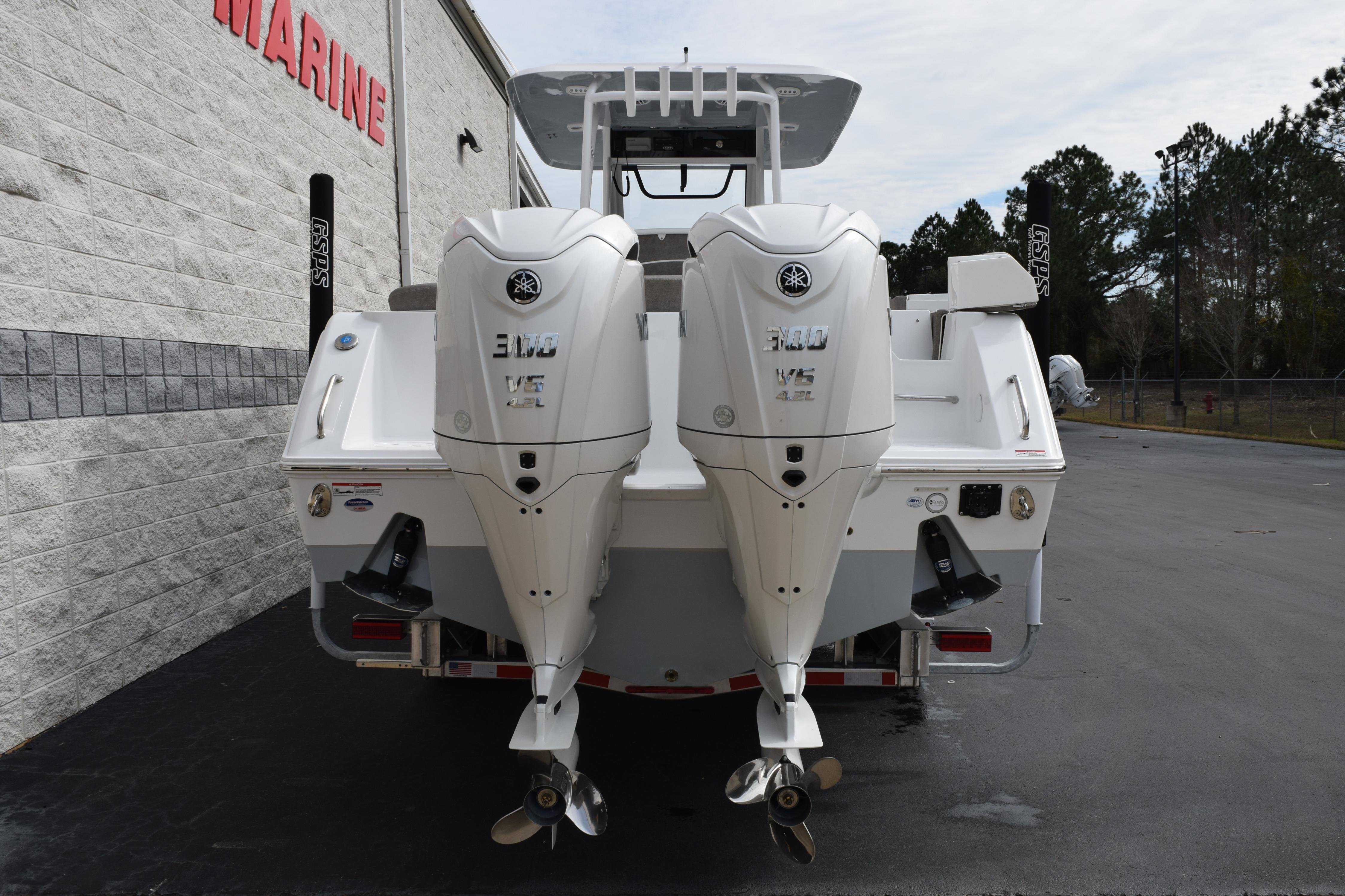 2026 Sea Hunt Ultra 285 SE boat with dual Yamaha 300 V6 engines, rear view.