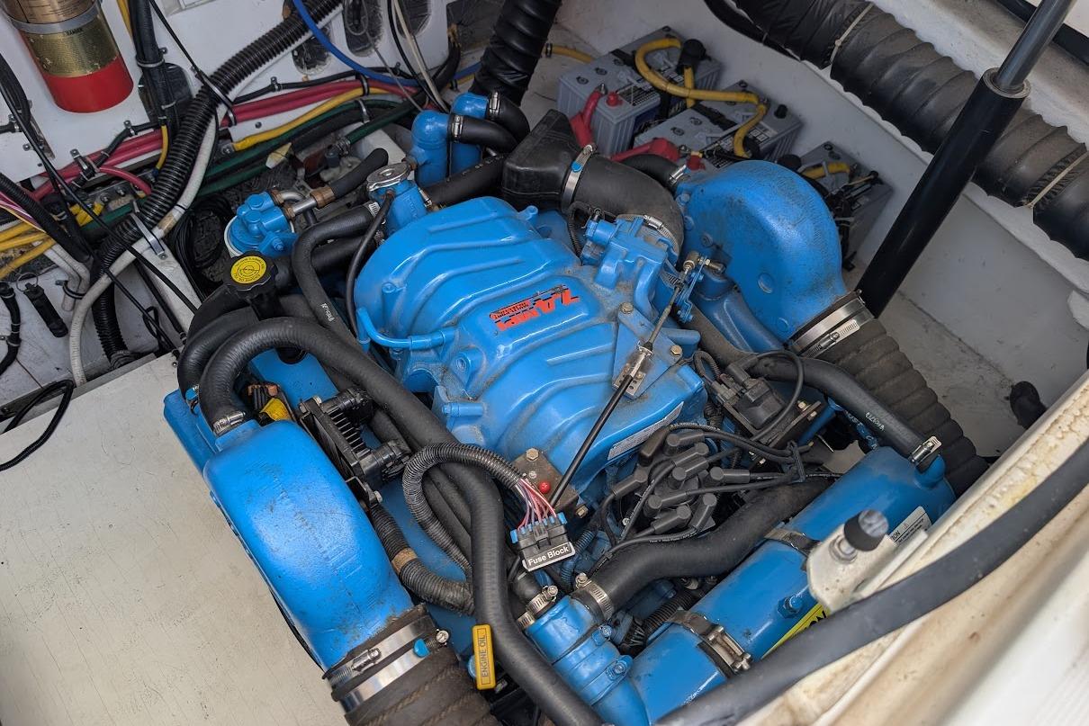 Engine compartment of a 2000 Pursuit 3400 Express boat, featuring a blue marine engine.