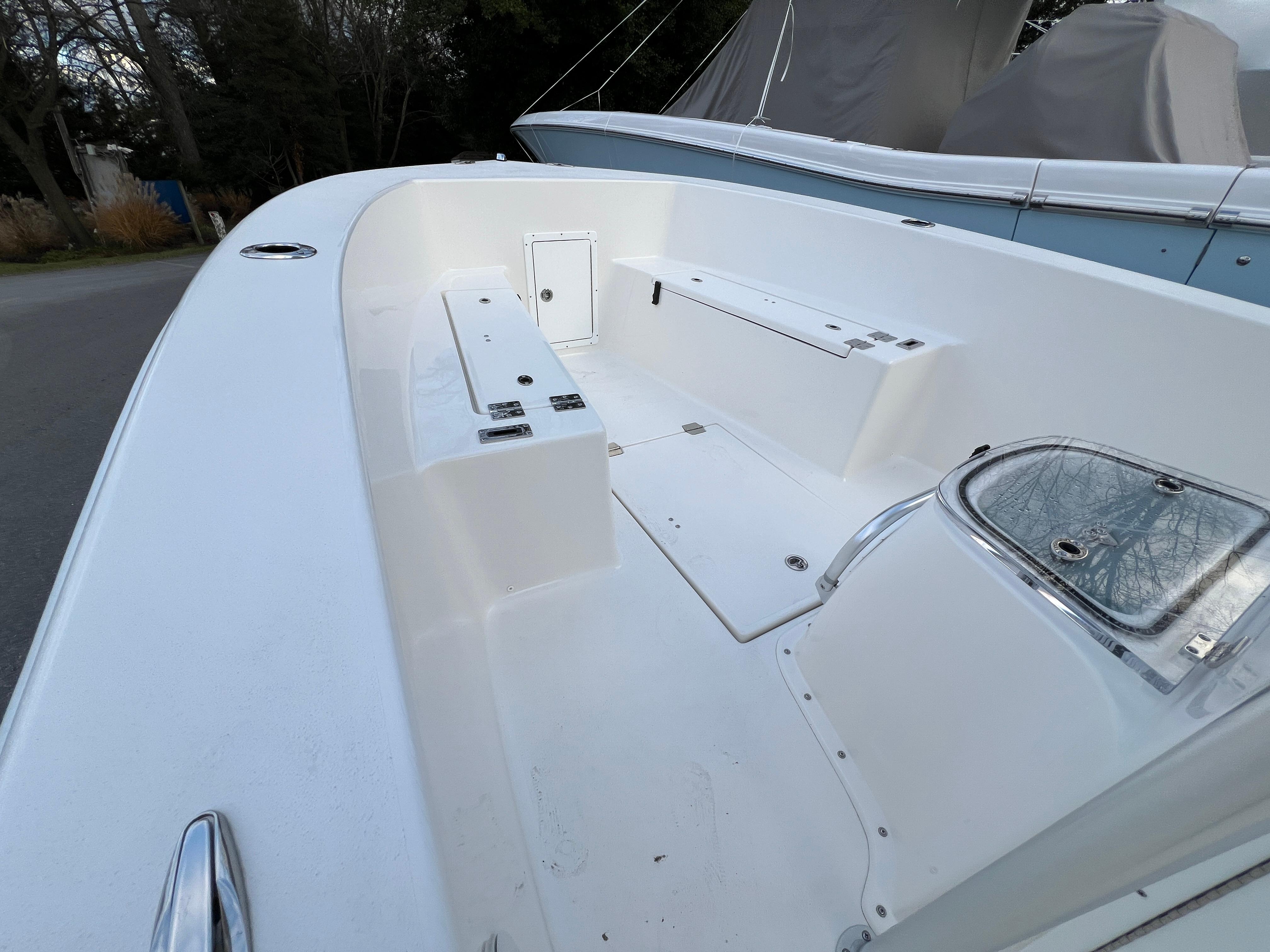 2024 KenCraft 21 boat interior with white seating and storage compartments.
