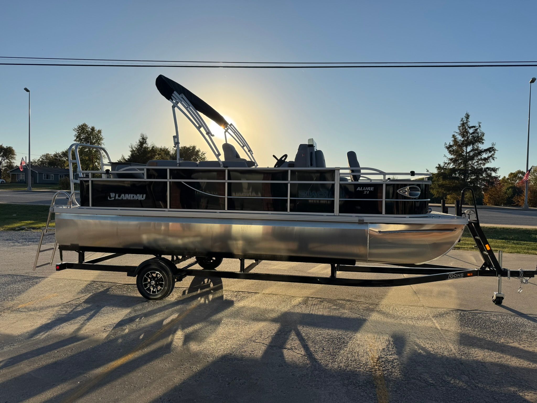 2026 Landau Alure 21CC Fish boat on trailer at sunset.