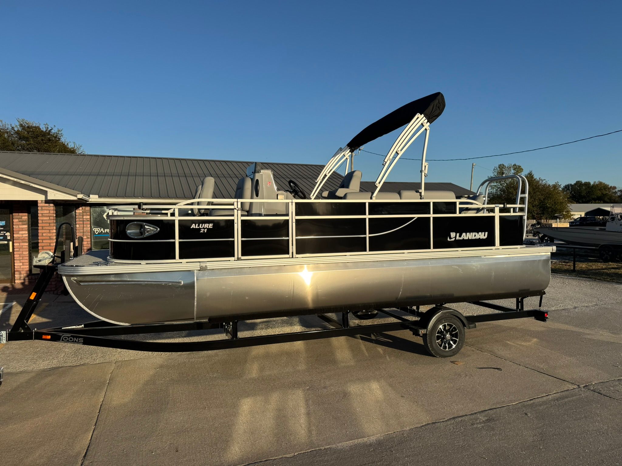 2026 Landau Alure 21CC Fish pontoon boat on trailer.