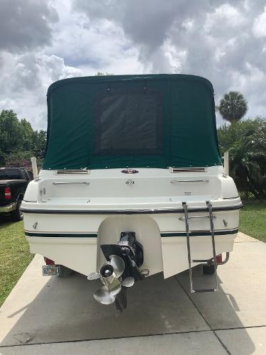 1998 Chaparral 2335 SS boat with green canopy, rear view.