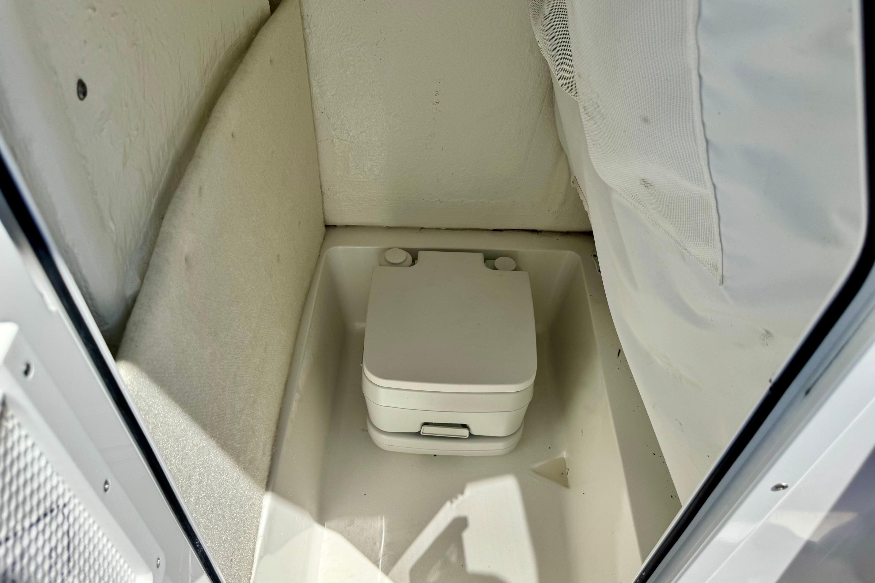 Portable toilet in 2025 Sea Hunt Ultra 219 boat cabin.
