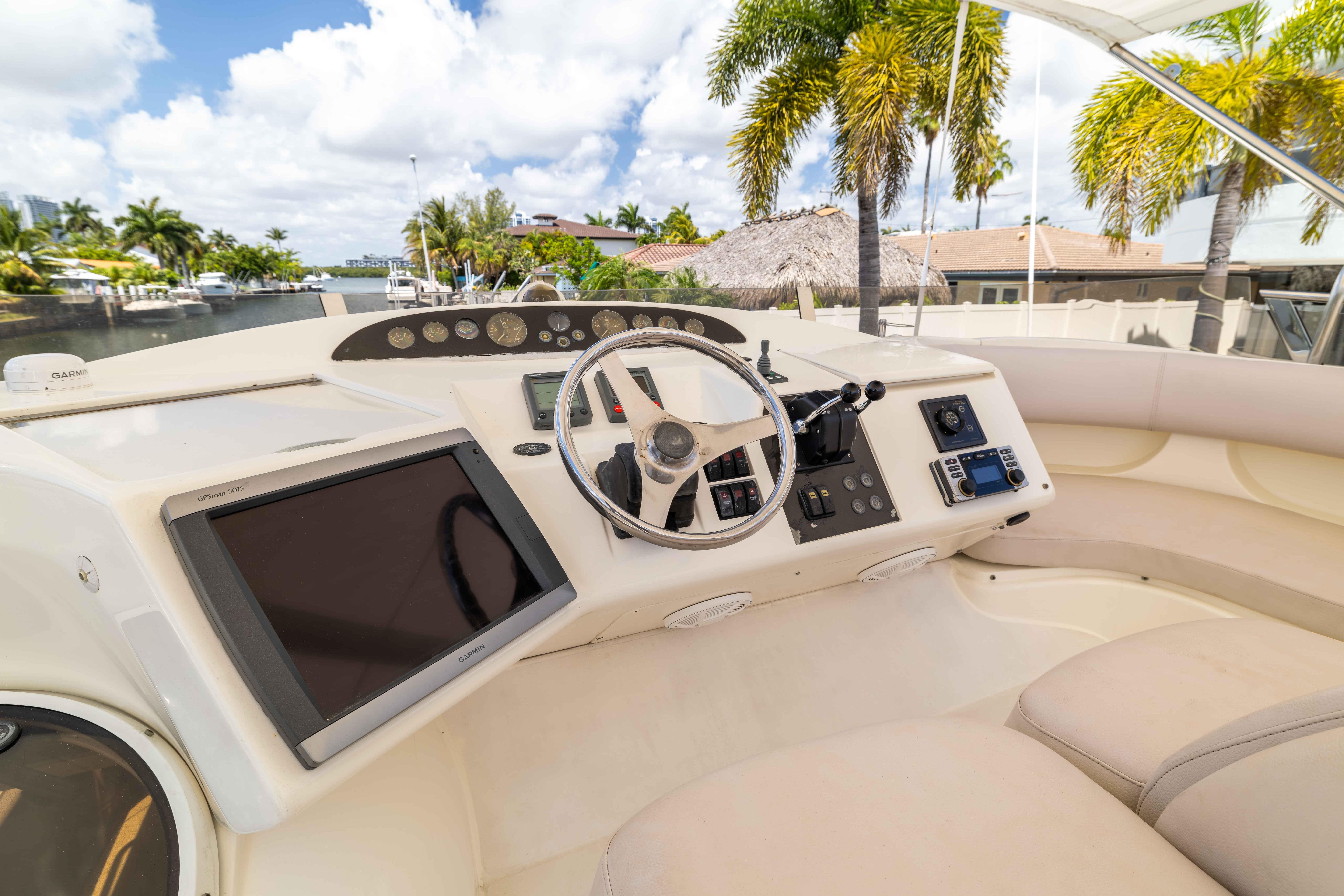 Luxurious 2002 Princess 61 yacht helm with modern navigation equipment and plush seating.