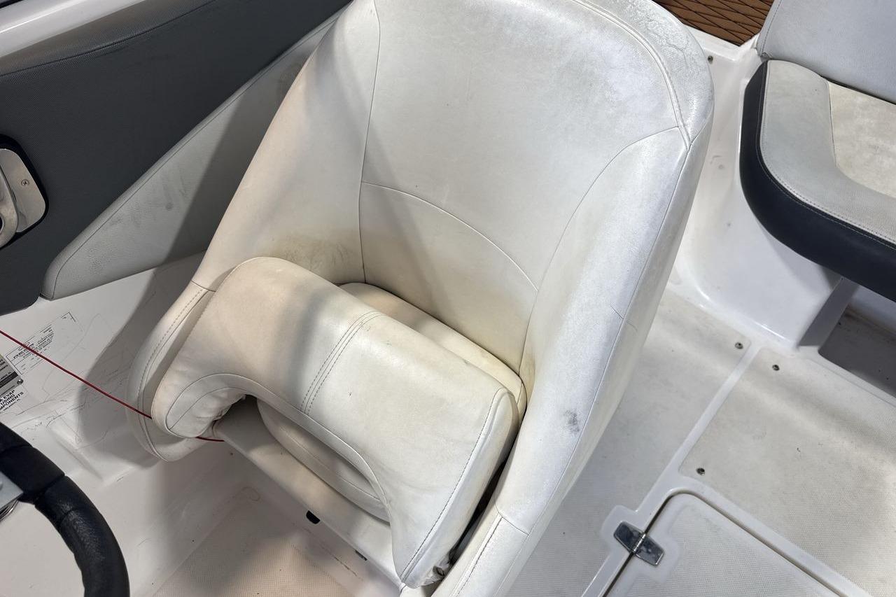 White leather seat in a 2012 Regal 1900 Bowrider boat interior.