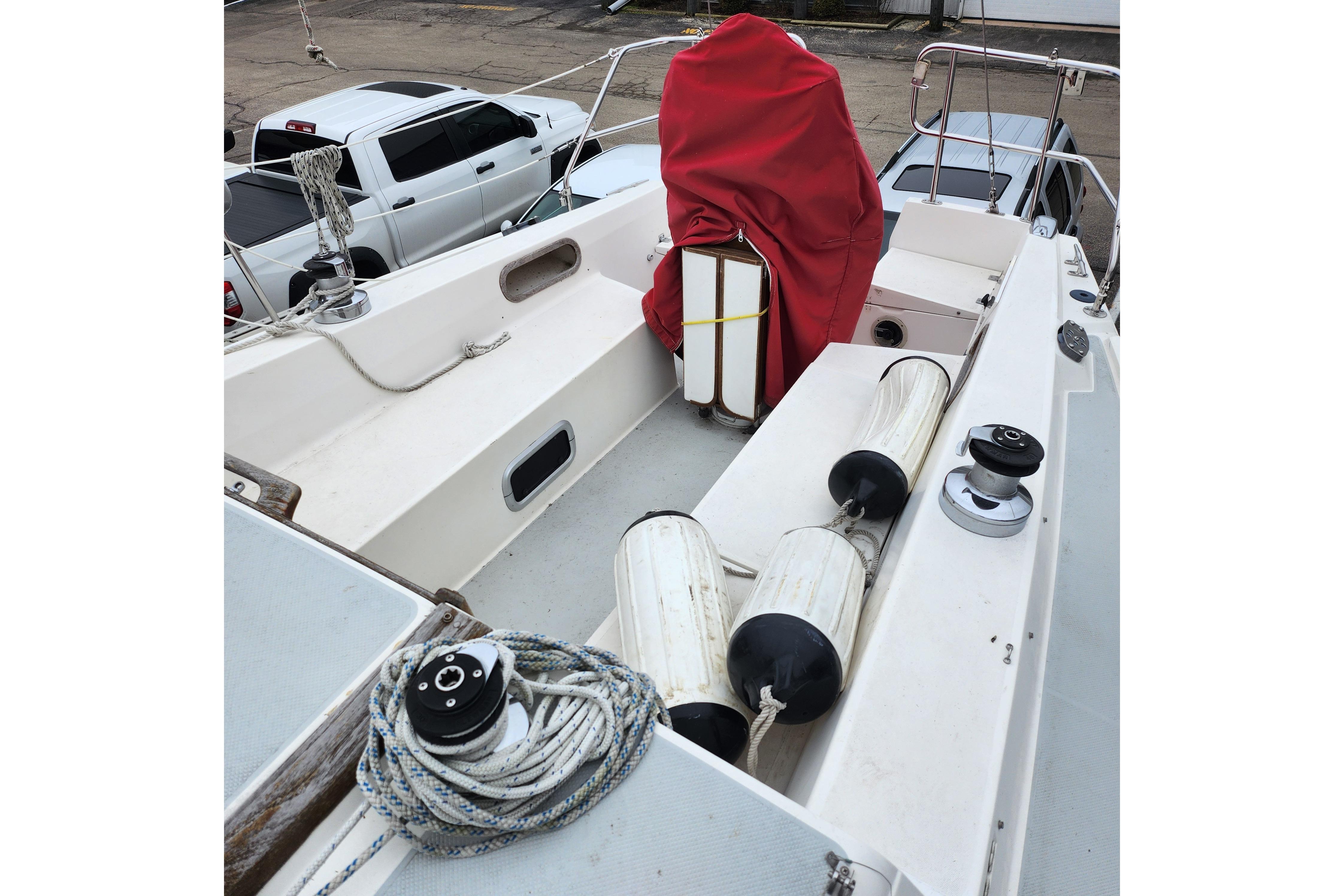 1992 Catalina 36 sailboat deck with ropes, fenders, and covered equipment.