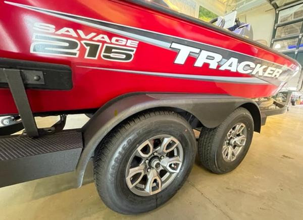 2025 Tracker Savage 215 boat trailer with dual wheels in a garage setting.