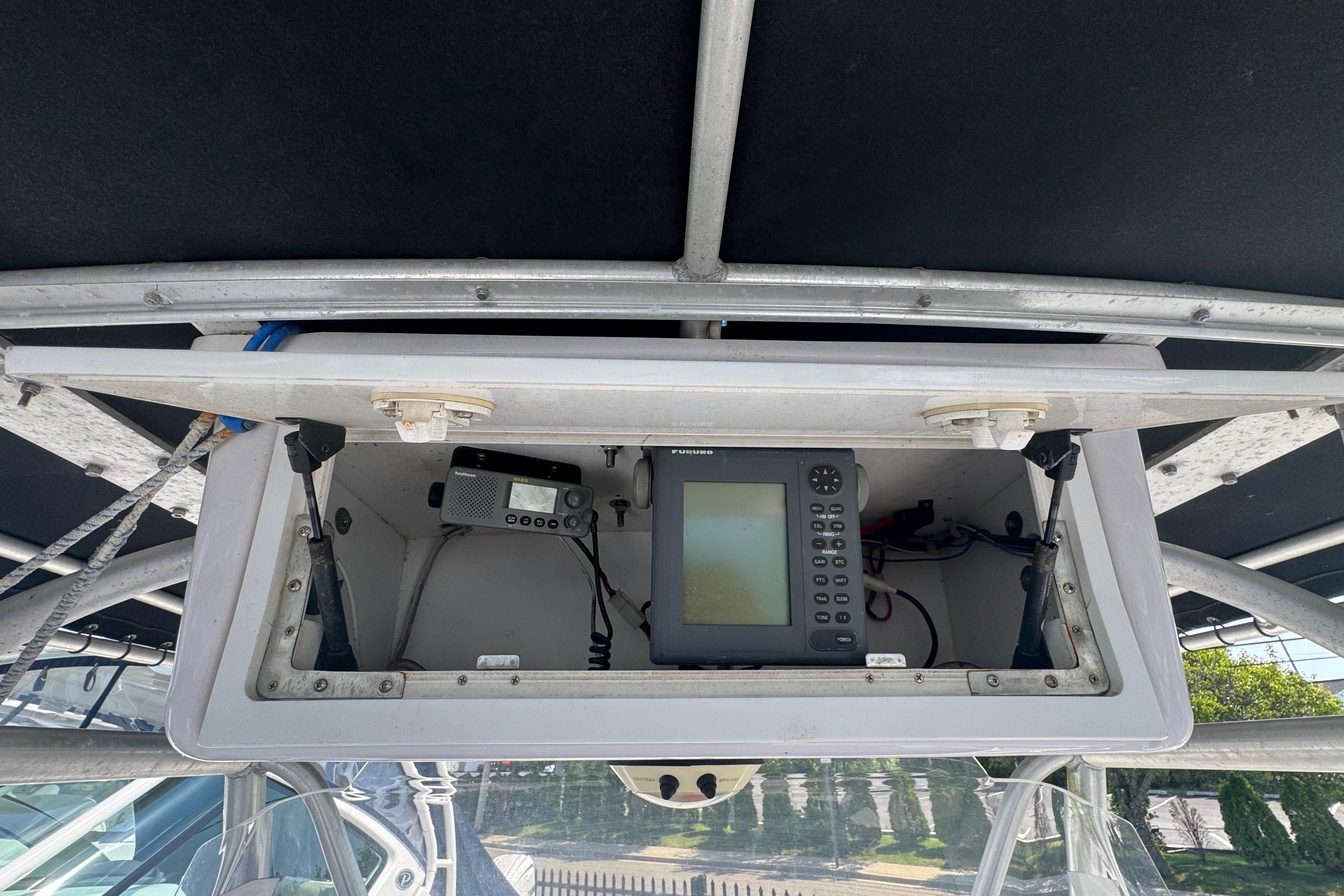 2002 Pro-Line 23 Sport boat electronics compartment with navigation and communication devices.