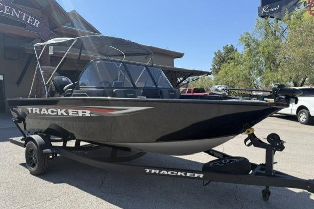 2026 Tracker Pro Guide V-175 Combo boat on trailer, parked outdoors.