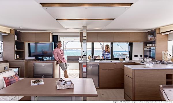 Modern interior of 2025 Lagoon 46 ICONIC yacht with spacious kitchen and ocean view.