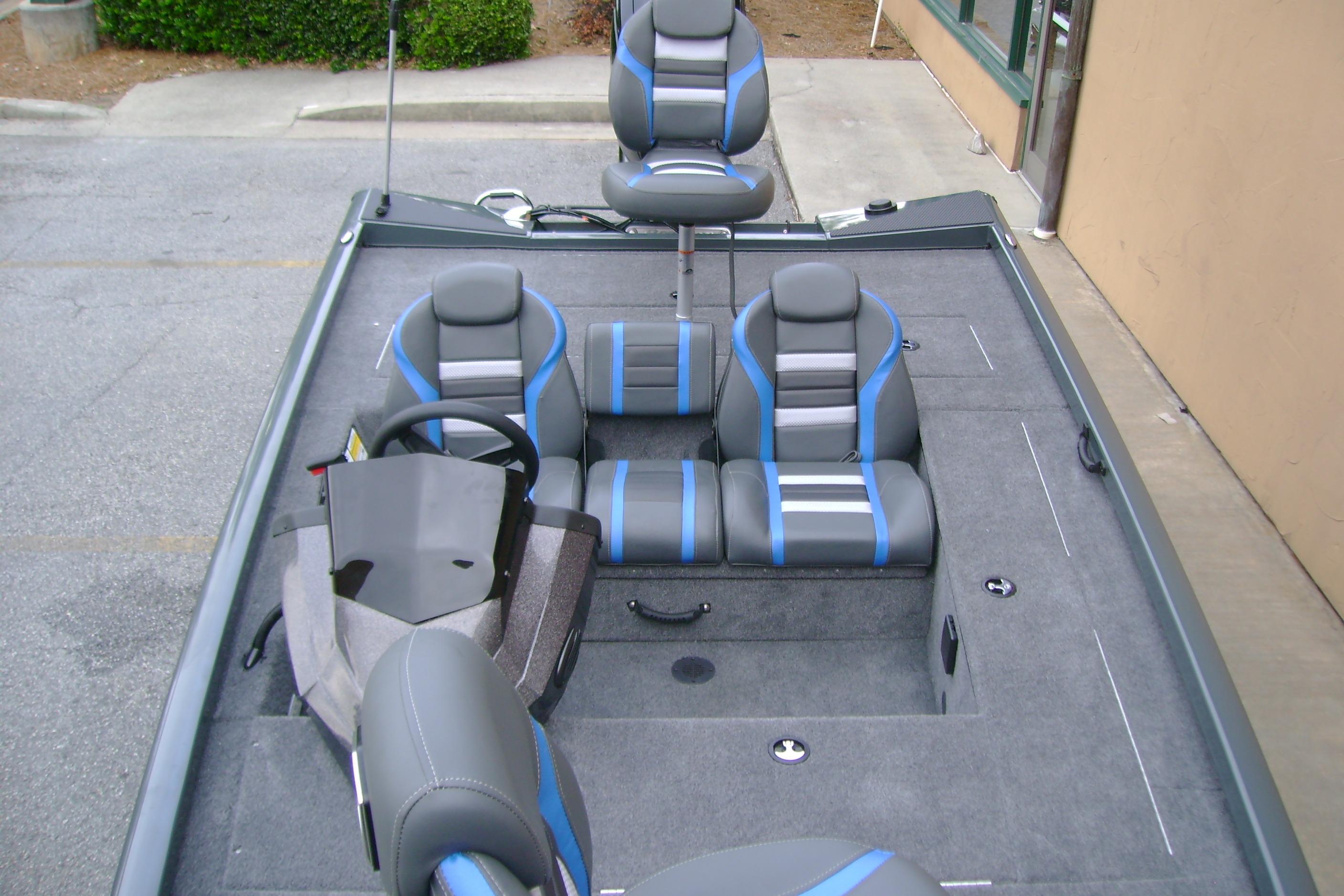 2026 Ranger RT178C boat interior with gray and blue seating, steering wheel, and carpeted deck.