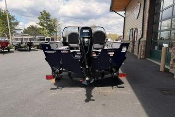 2026 Tracker Pro Guide V-16 WT boat with 60 HP engine, parked outdoors.