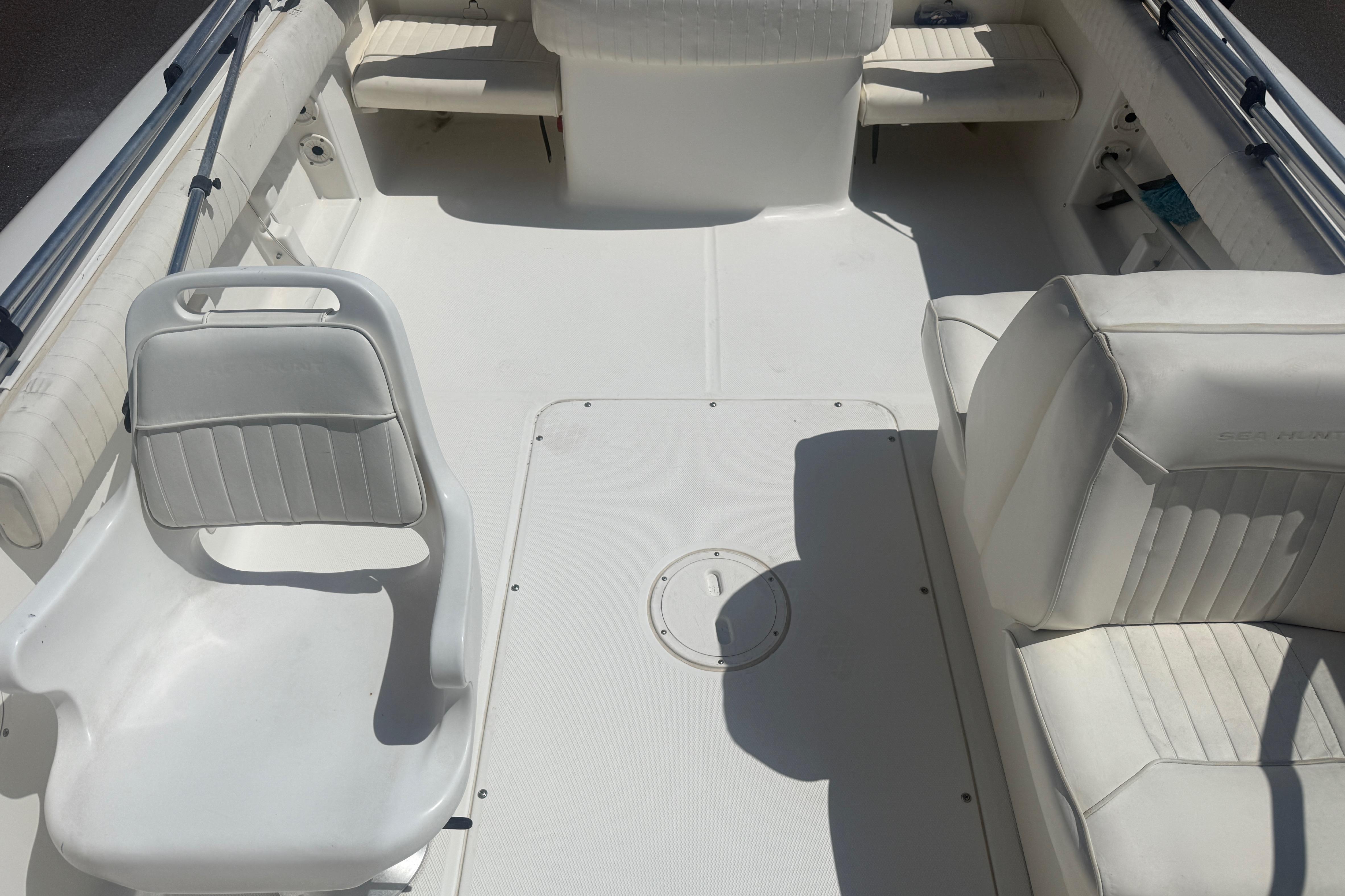 2006 Sea Hunt Escape 200 boat interior with white seating and clean deck.