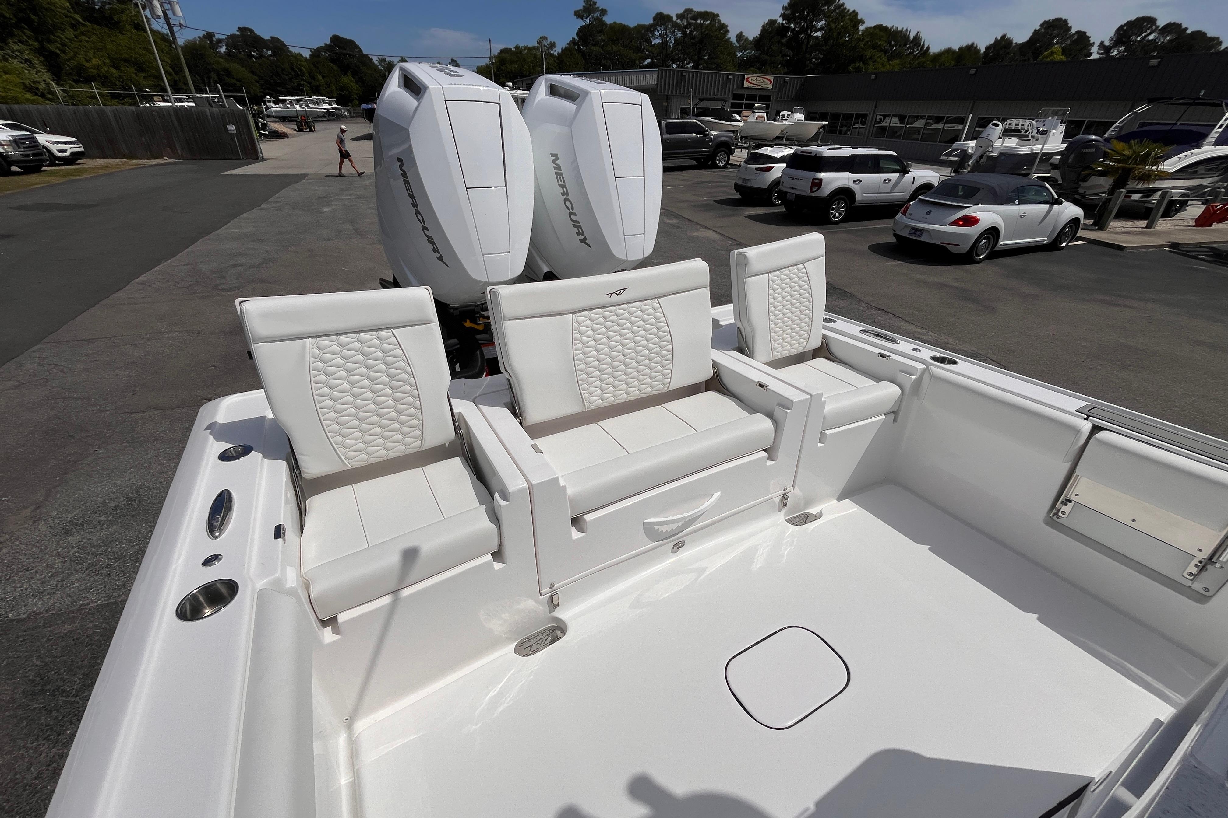 2026 Tidewater 3100 Carolina Bay boat with white seating and dual Mercury engines.