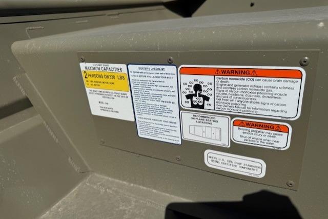 2026 Tracker Grizzly 10 Jon boat warning and capacity labels on interior panel.