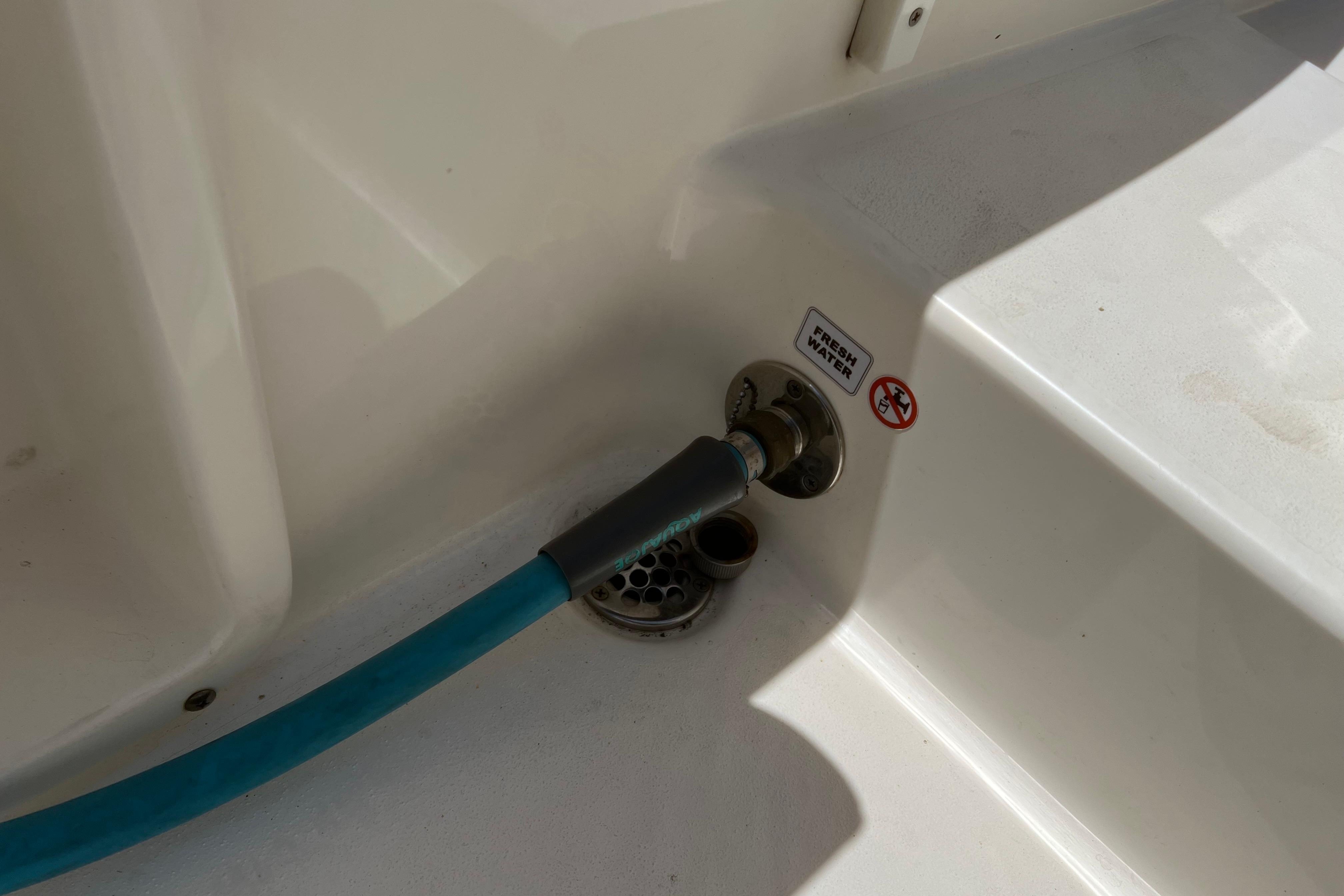 Freshwater hose connection on 2018 Cobia 201 Center Console boat.