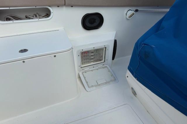 2005 Dakota 36 CC Forward Cuddy Cabin interior with storage compartments and blue cover.
