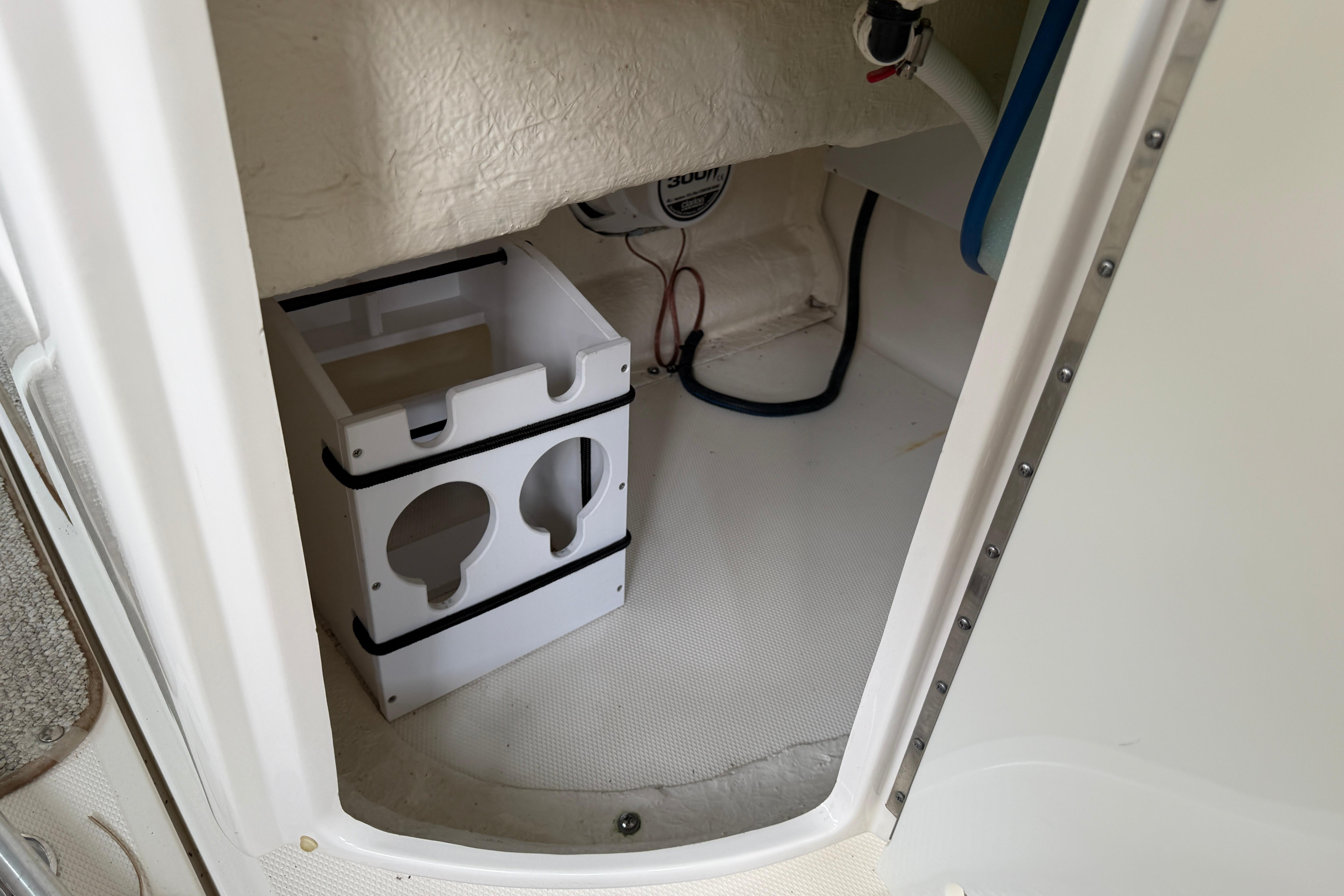 Interior storage compartment of a 2003 Sea Ray 290 Bowrider boat.