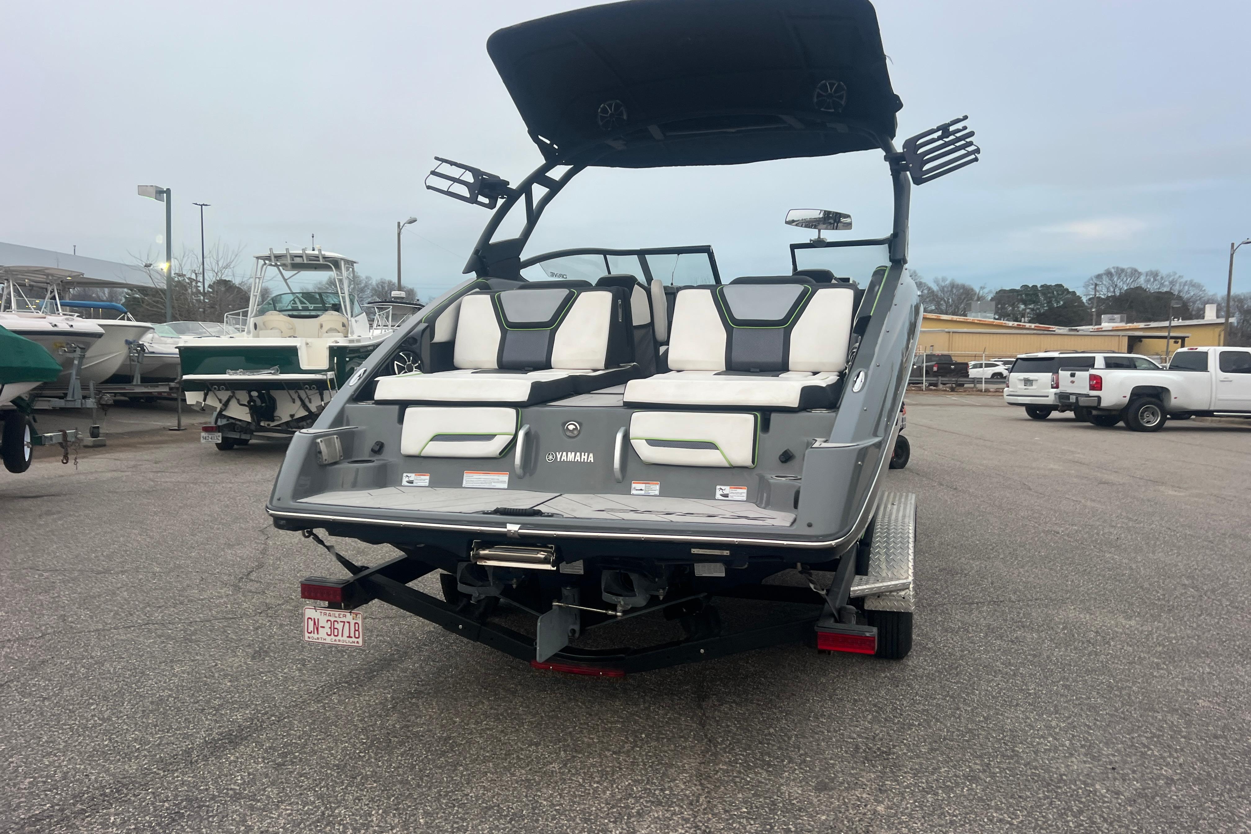2021 Yamaha Boats 255XD, rear view, parked on trailer in a marina lot.