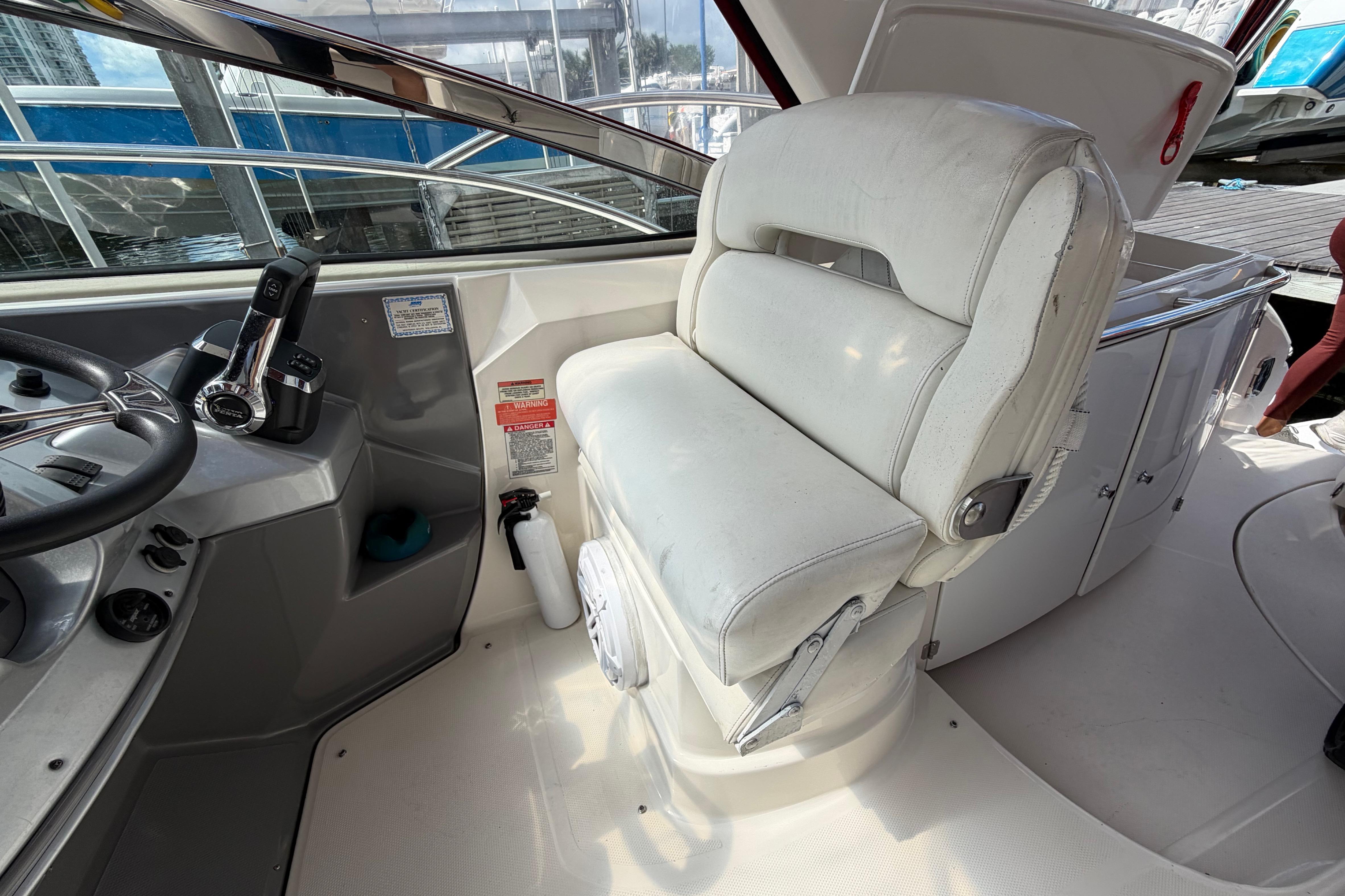 Captain's seat and helm of a 2007 Monterey 350 Sport Yacht, featuring steering controls.
